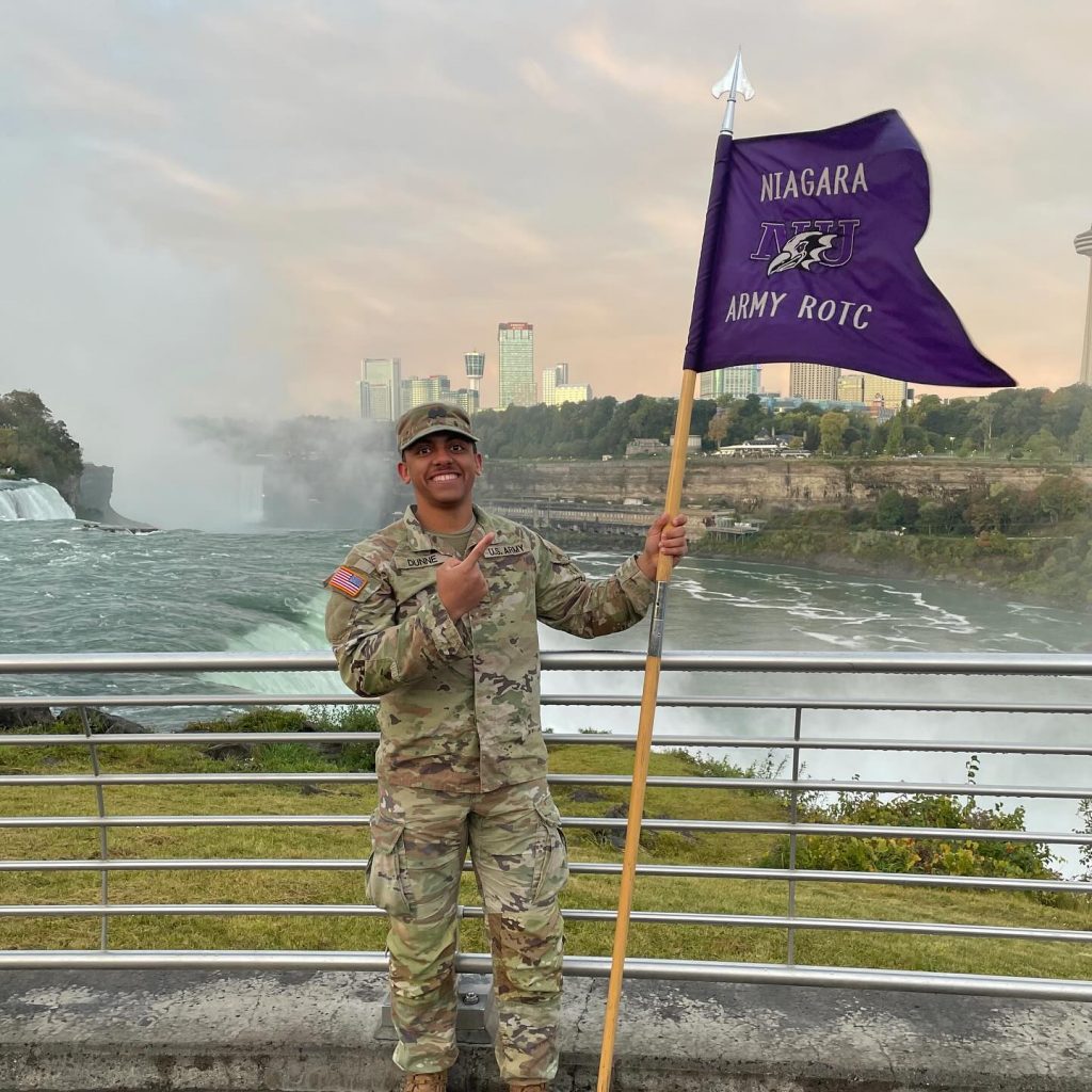 History Cadet Holding NU Flag By the Niagara Falls