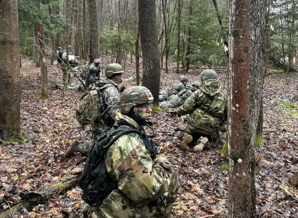 Cadets hiding in the woods with camouflage on